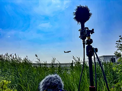 Directional microphone capturing aircraft in flight — tarmac field recording session
